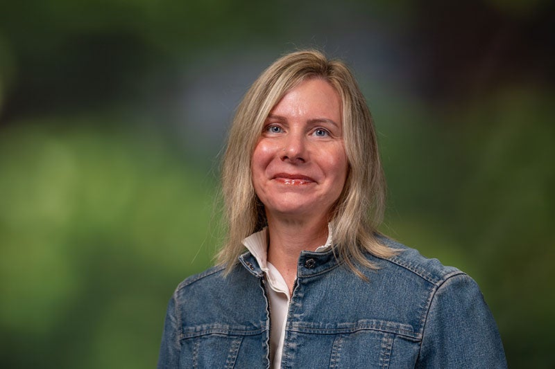 Woman with long blond hair wearing a denim jacket