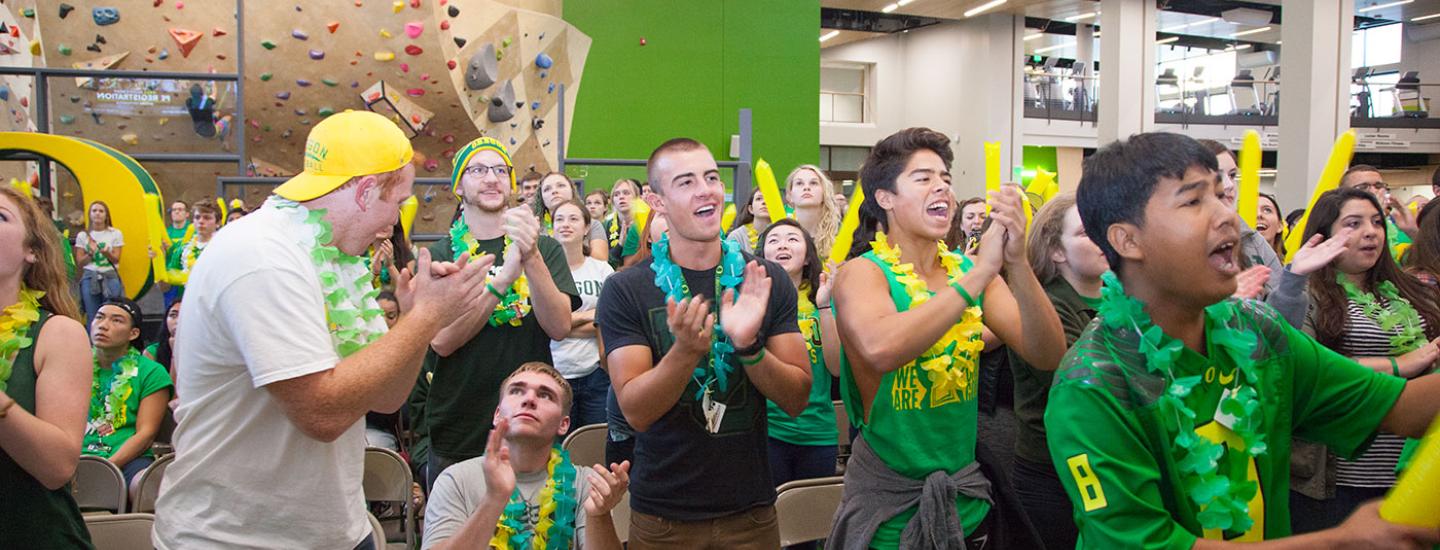 Students yell with excitement during a Ducks watch party in the Student Recreation Center.