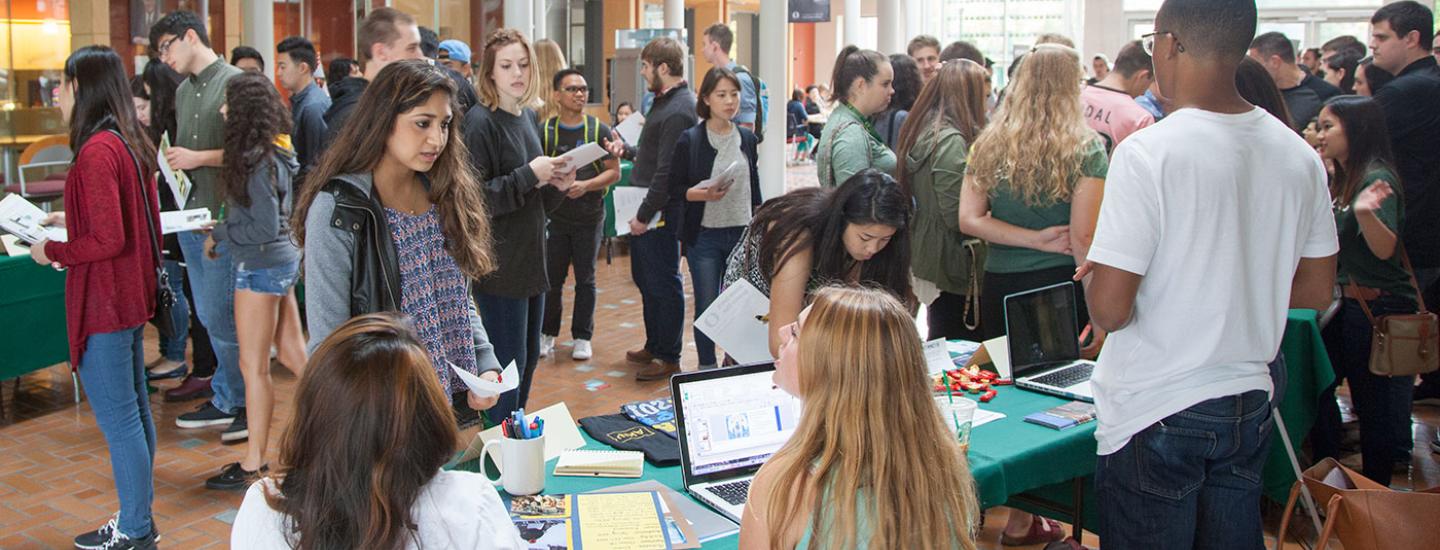 Many leadership and career support exist at the University of Oregon. Students in a crowded career fair.